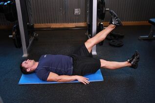 Man with prostatitis is exercising in gym